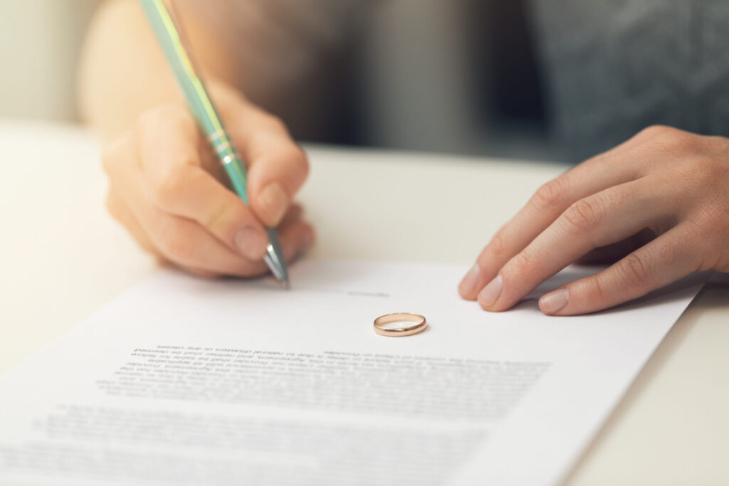 woman signing marriage divorce papers