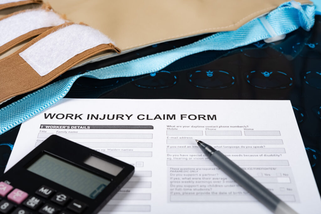 work injury claim form with CT film medical and insurance concept