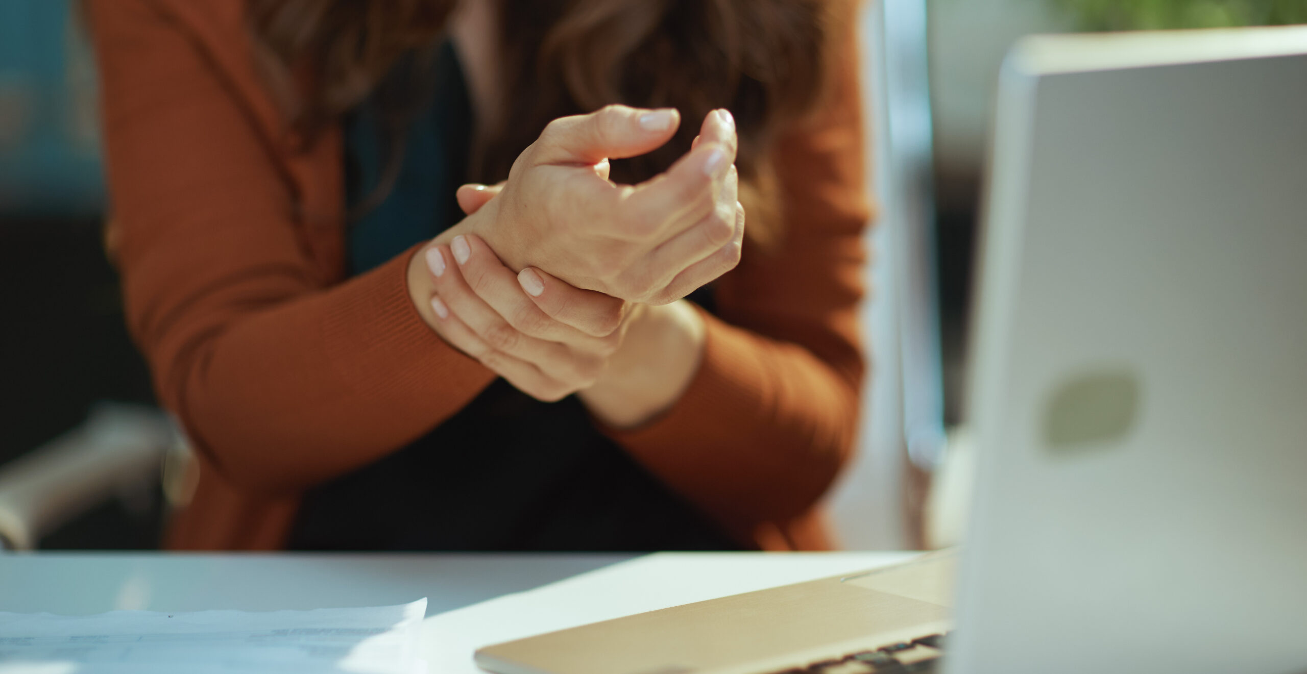 Business owner woman in green office experience carpal syndrome